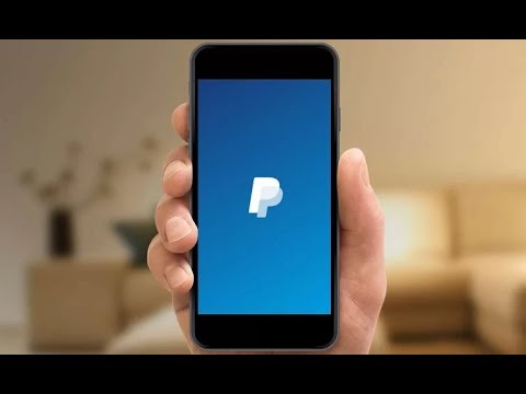 person holding phone with paypal on the screen