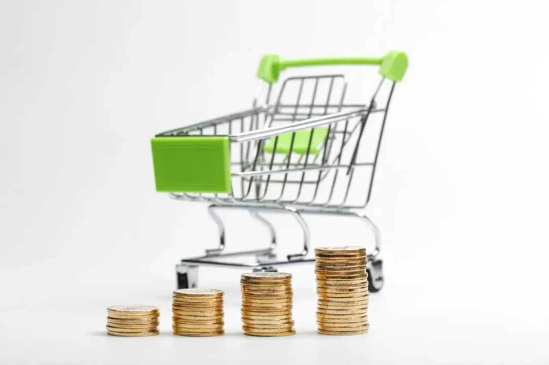 coins-pile-shopping-cart-white-background