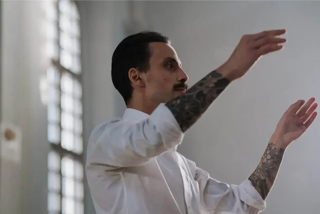 man-in-white-dress-shirt-with-arm-tattoos