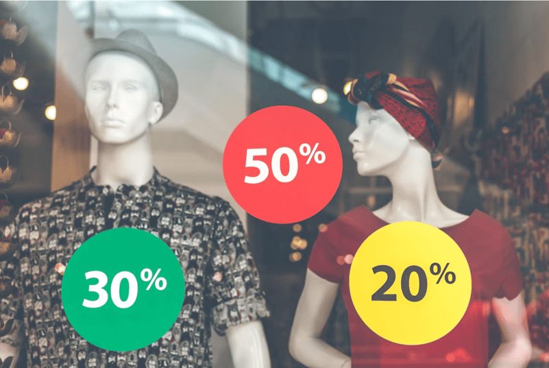 mannequins in window advertising percent discounts