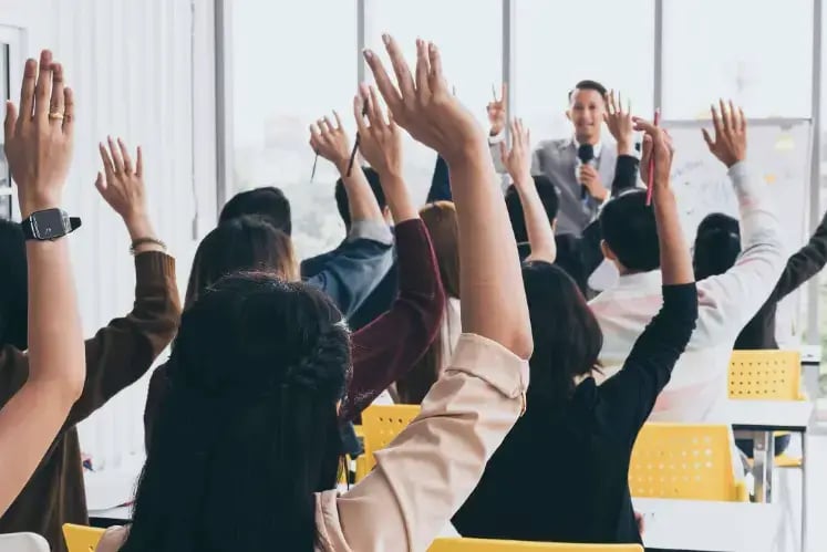 meeting-employees-raising-hands