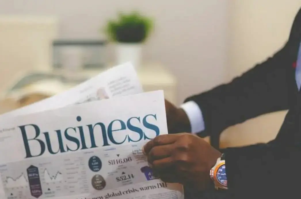 person-reading-business-finance-management-newspaper