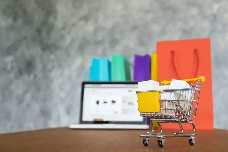 small-shopping-cart-in-front-of-laptop