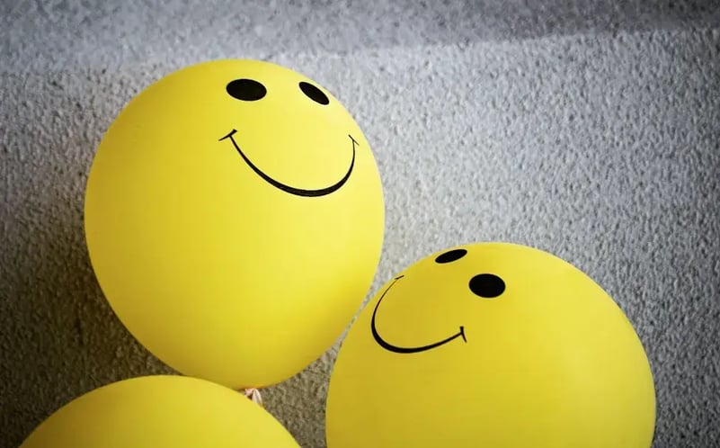three-yellow-balloons-with-smiley-faces