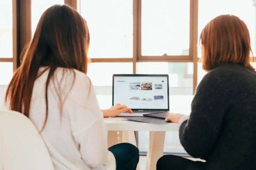 two-women-looking-at-laptop-screen