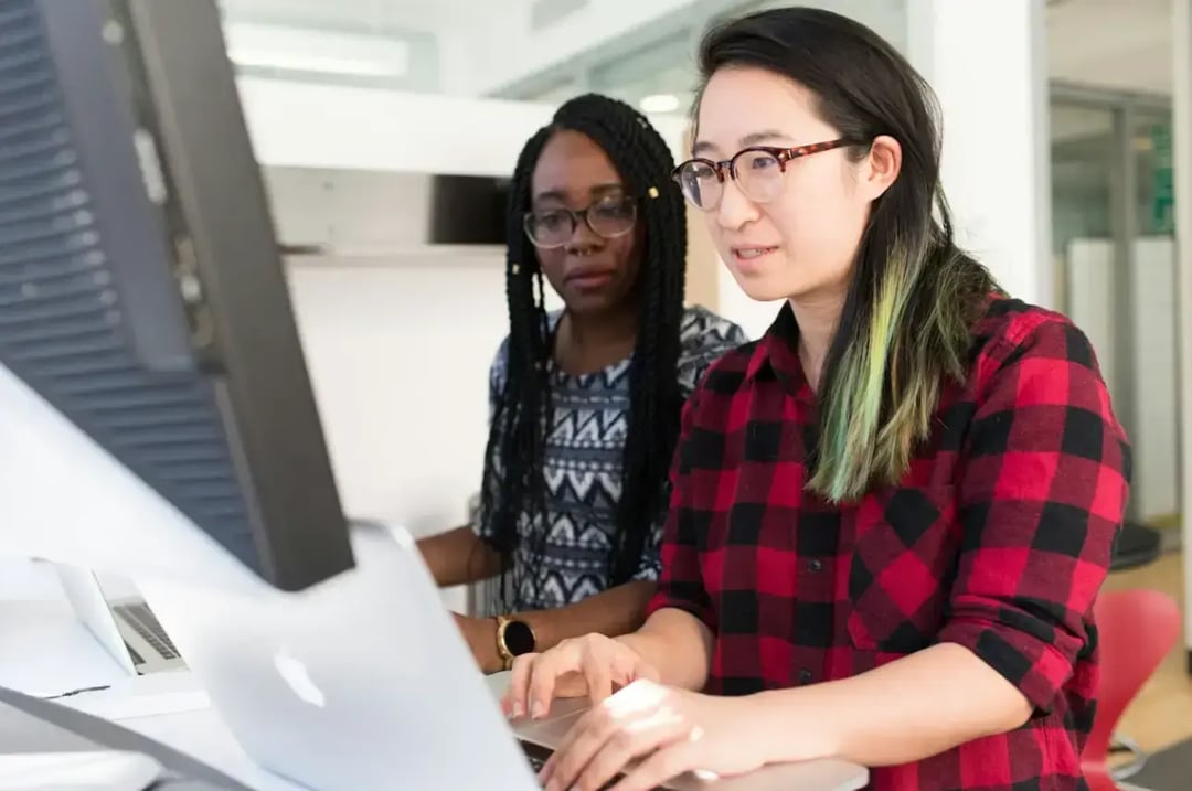 woman-wearing-red-and-black-checkered-blouse-using-flat-screen-computer