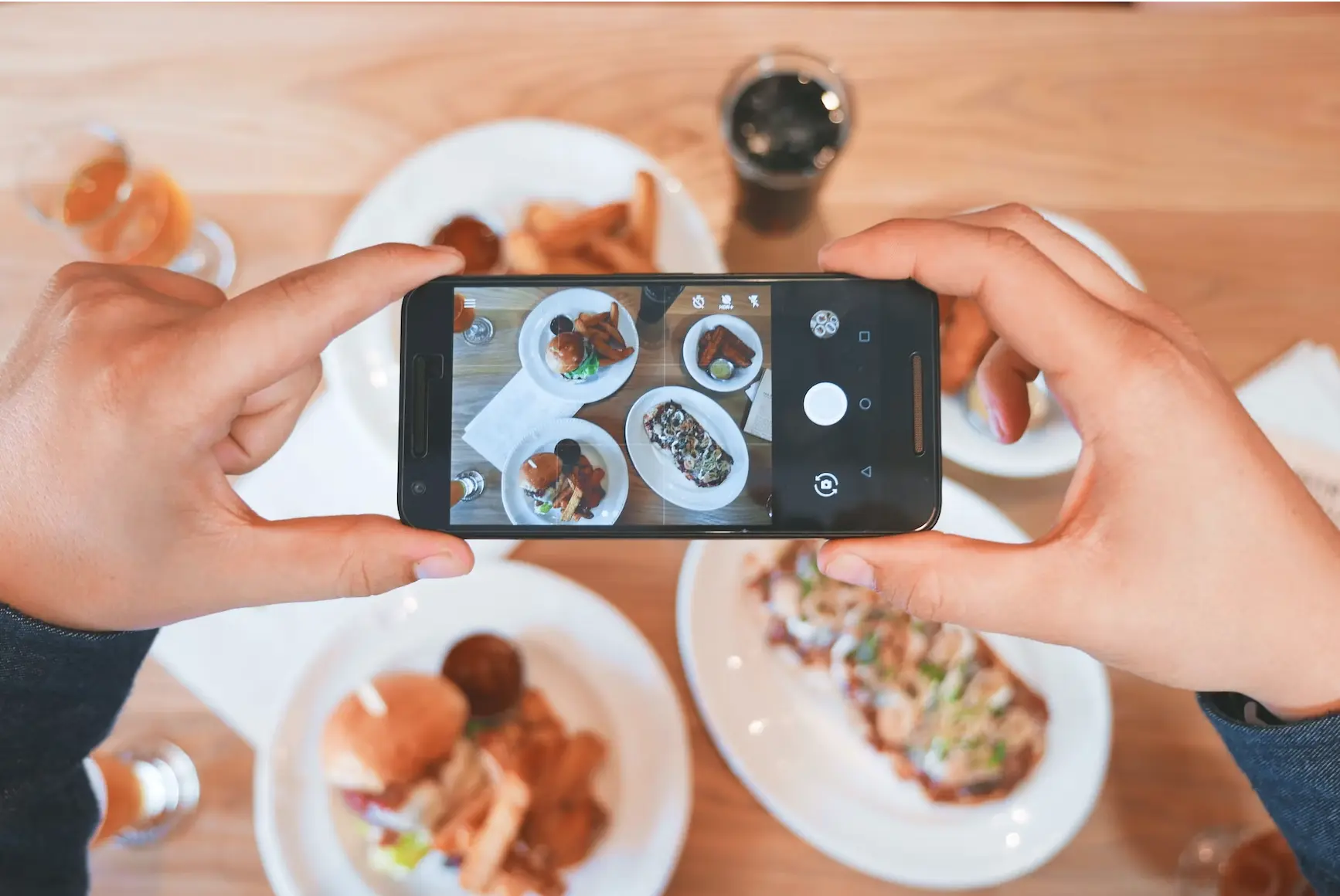 person taking picture of food